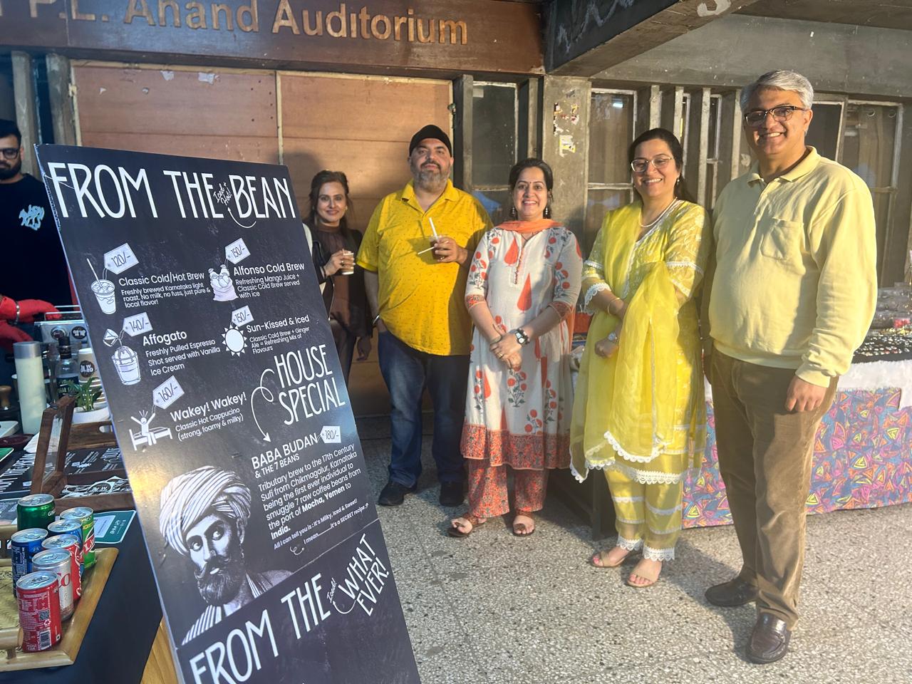 Brew Date guests posing with the branded menu board